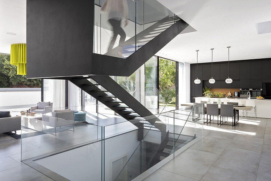 L-Shaped Home Organized Around a Central Steel Staircase 4