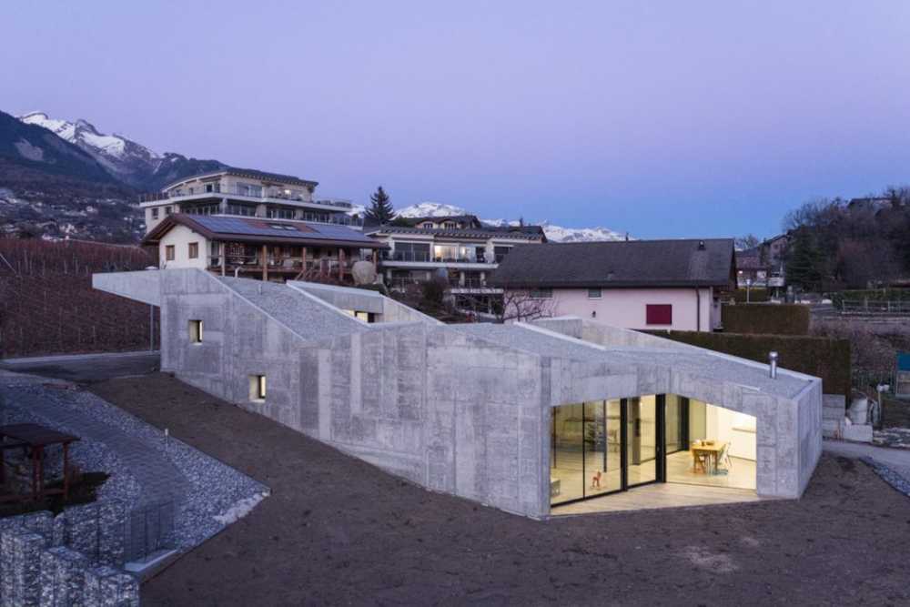 Massive Concrete Family House with Generous Inner Apertures to the Light