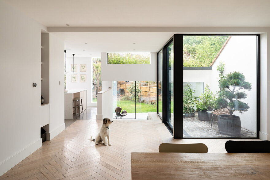 View to garden from dining room across courtyard, London Courtyard House by Fraher and Findlay