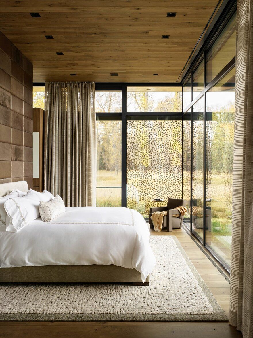 Inspiration is easily found in the earth-toned bedroom—from the trees just beyond the expansive glass.