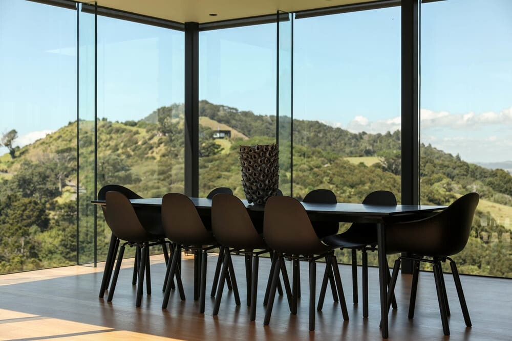 The dining area is fully glazed with views over the surrounding landscape.
